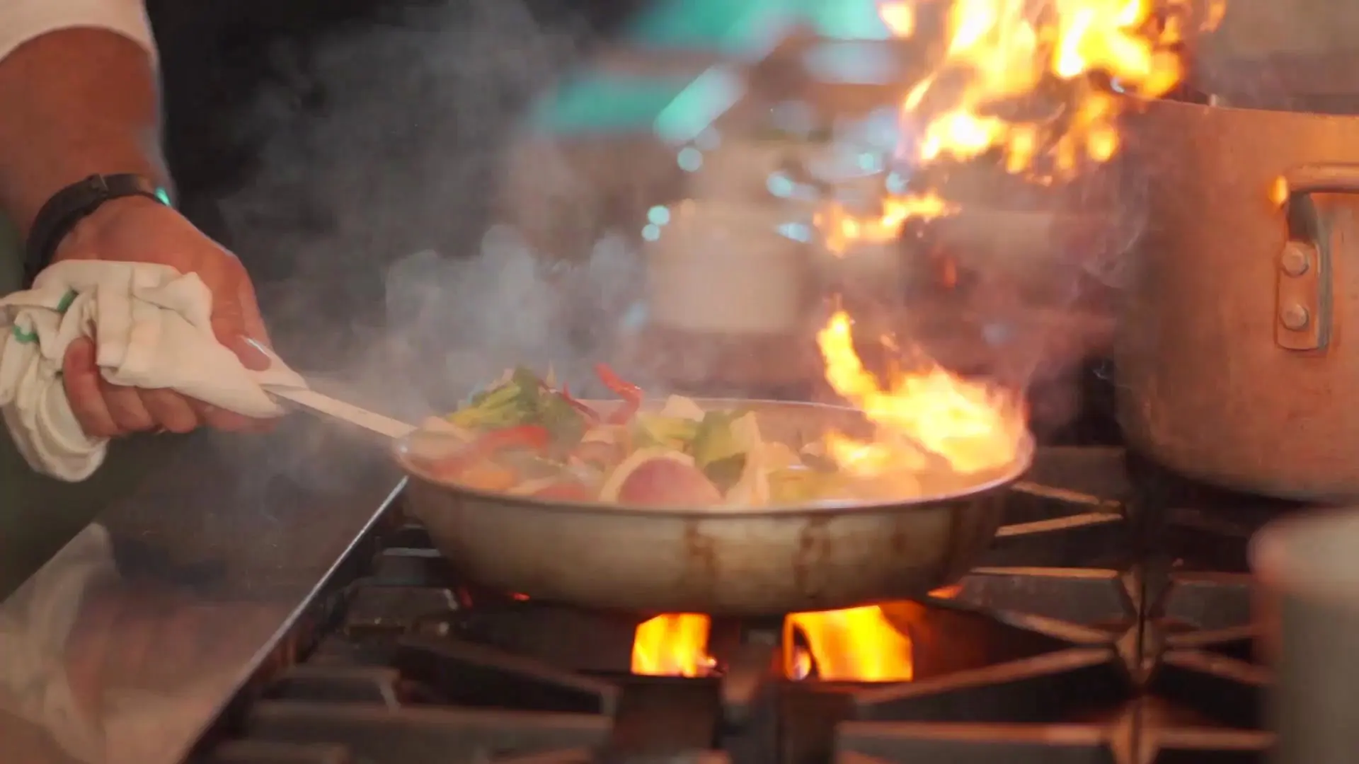 Flames rising from a pan in the Delhi Garden kitchen