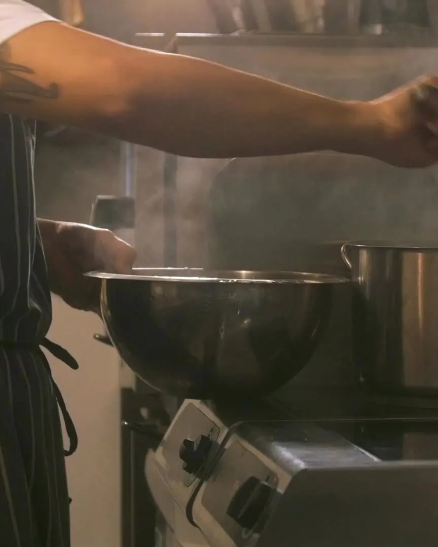 A cook at the range in the Delhi Garden kitchen